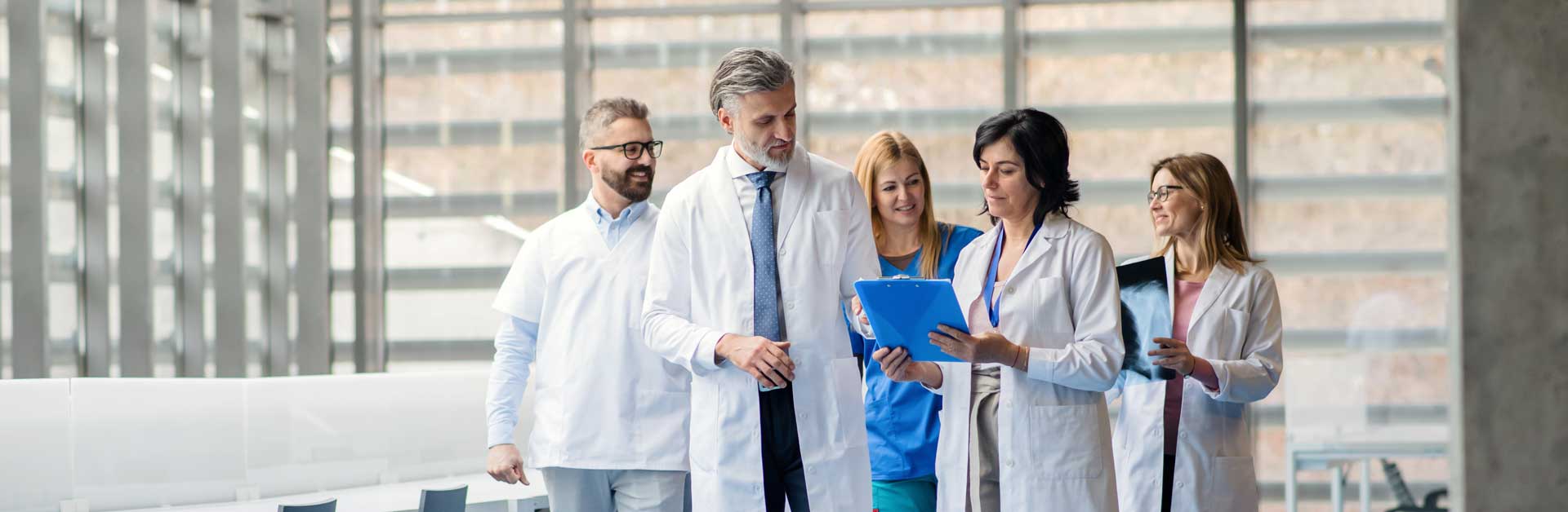 group-of-doctors-walking-in-corridor-on-medical-co-WHEP3XW-b.jpg