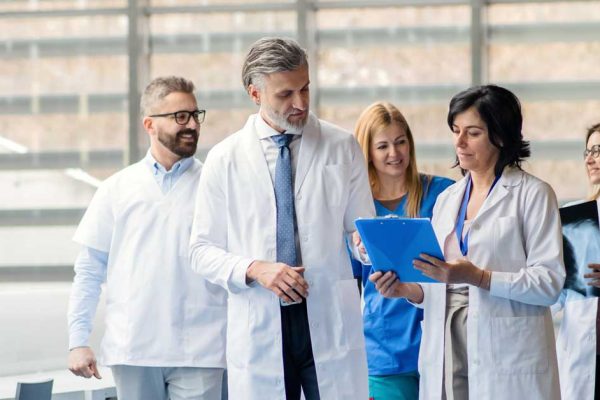 group-of-doctors-walking-in-corridor-on-medical-co-WHEP3XW-b.jpg
